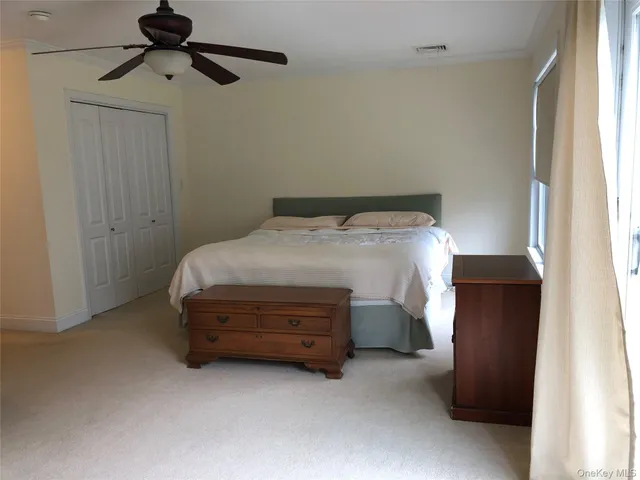 a bed room with a bed and a chair