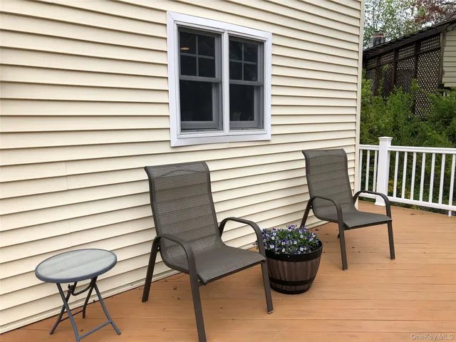 a view of a chair and table in back side of the house