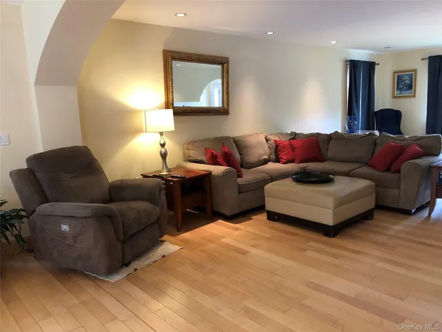 a living room with furniture and a lamp