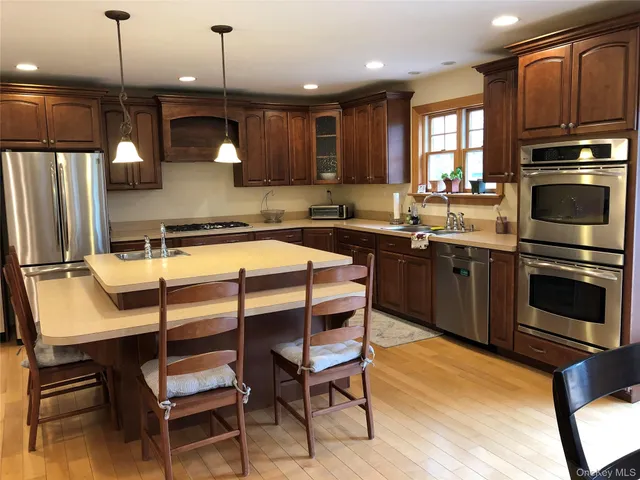 a kitchen with a sink appliances and cabinets
