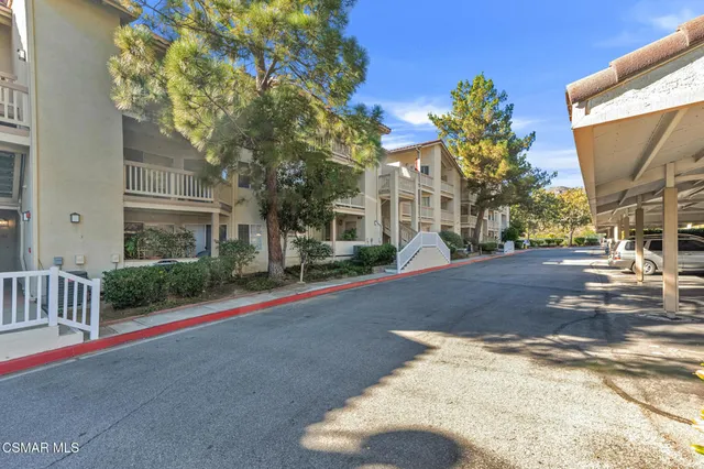 a view of a street with houses on both side