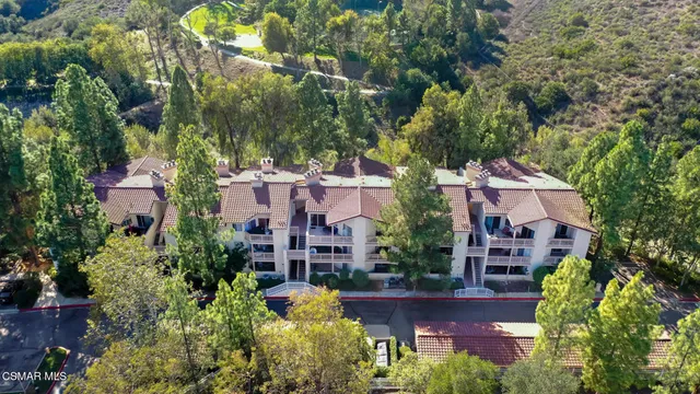 an aerial view of multiple houses with yard