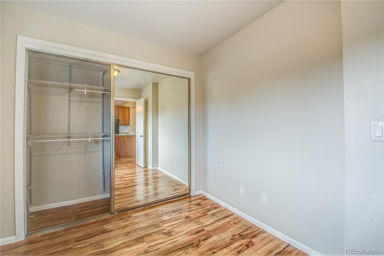 2271 South Buckley Road, Unit 202 Aurora, CO 80013 - Photo 5 of 18 a view of wooden floor in an empty room