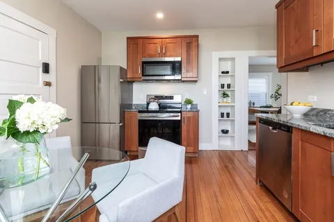a kitchen with stainless steel appliances a stove refrigerator sink and cabinets