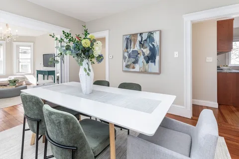 a view of a dining room with furniture and chandelier