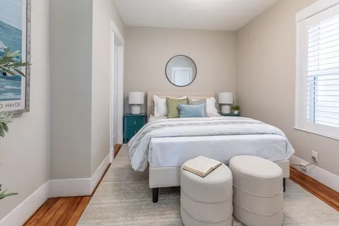 a bedroom with a bed and a window