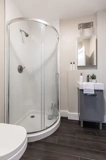 a bathroom with a sink a toilet and shower