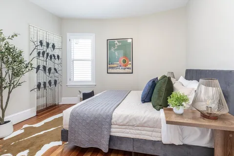 a bedroom with a bed and a window