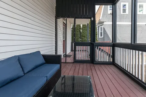a view of a two chairs in the balcony