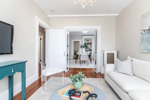 a living room with furniture and a potted plant