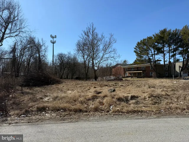 a view of a house with a yard covered with snow
