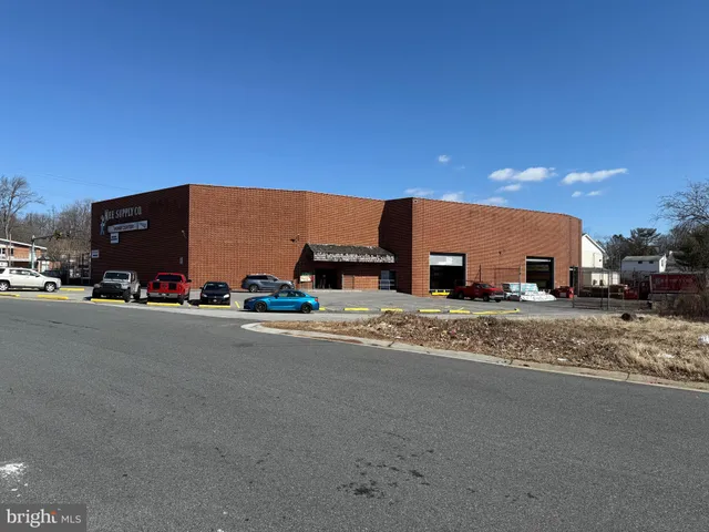 a view of a street with a car parked on the road