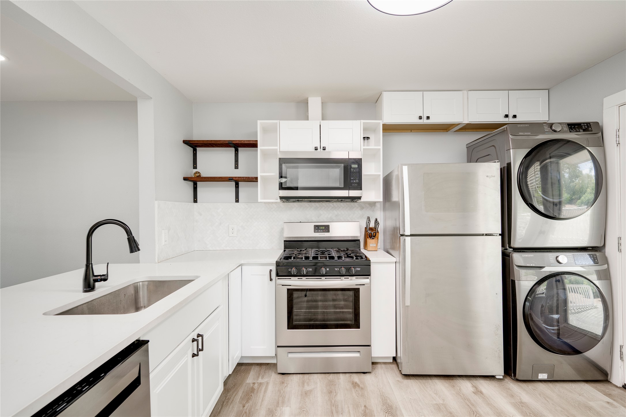 1400 Marcus Place, Unit B Austin, TX 78721 - Photo 23 of 39 A compact culinary space designed for efficiency, featuring a full suite of stainless steel appliances.