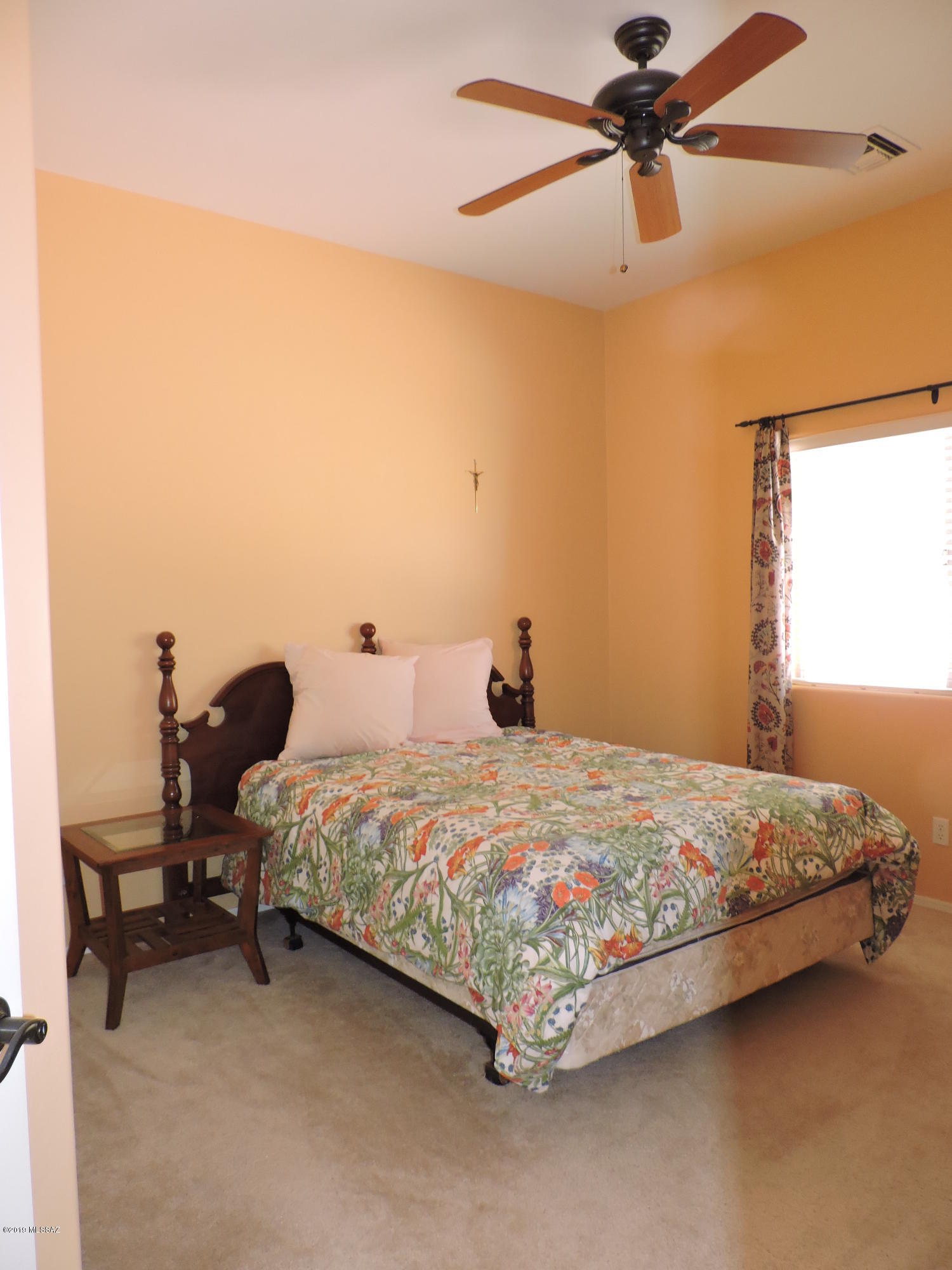 1786 Zimmer Court Rio Rico, AZ 85648 - Photo 36 of 42 a bedroom with a bed and a chandelier