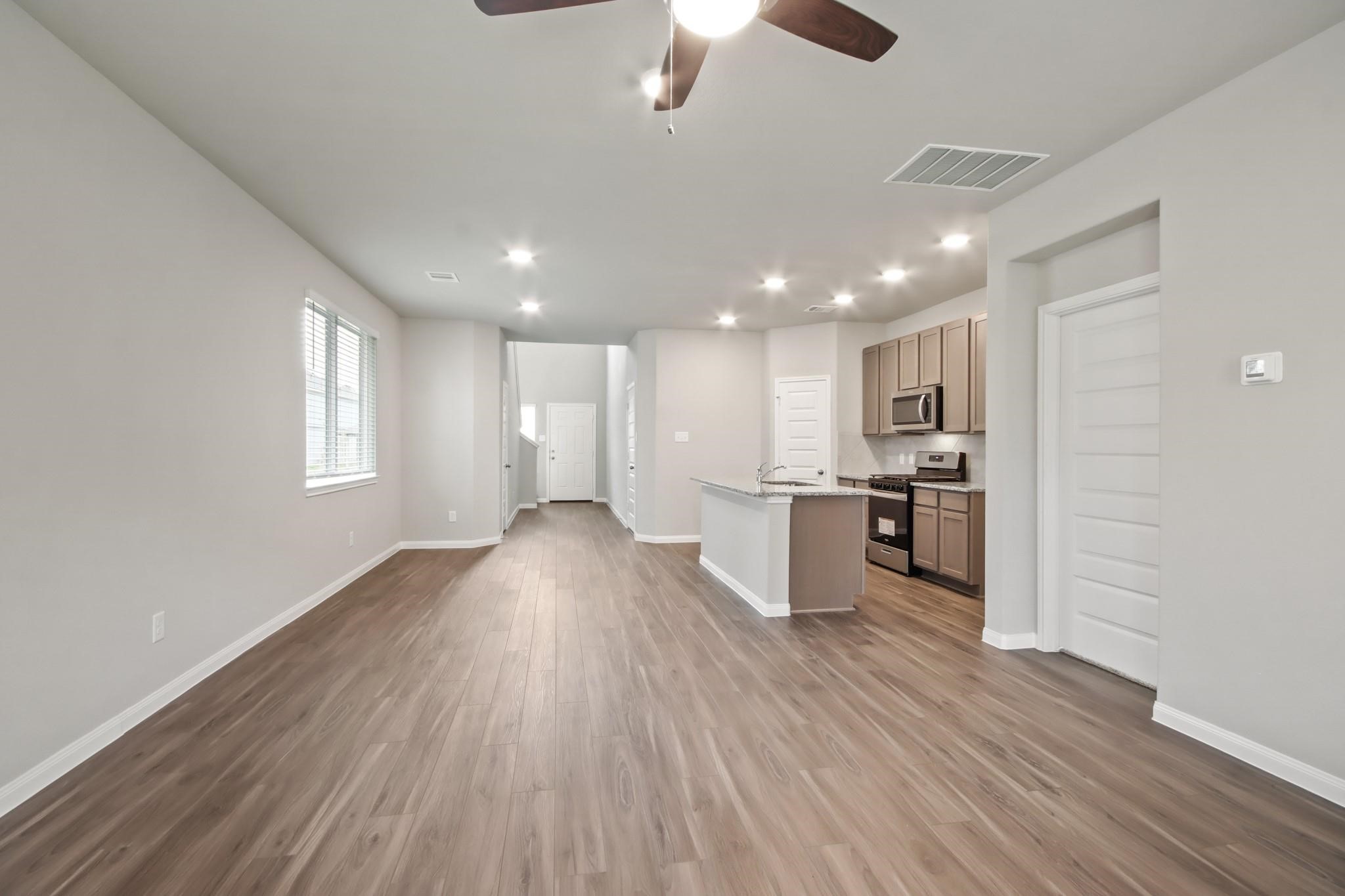 2416 Bluefish Court Conroe, TX 77384 - Photo 2 of 45 a view of kitchen with sink and wooden floor