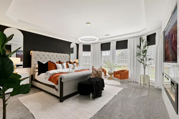 a spacious bedroom with a bed couch and a window