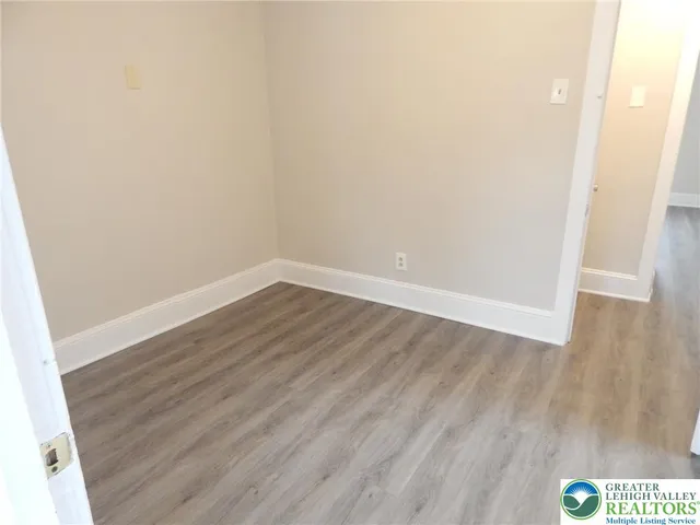 an empty room with wooden floor