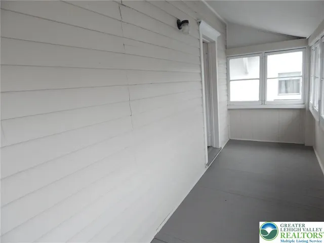 a view of an empty room and a window