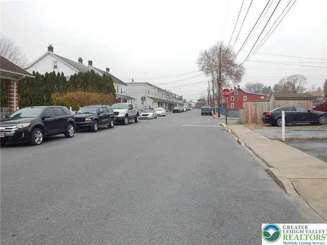 a view of street with parked cars
