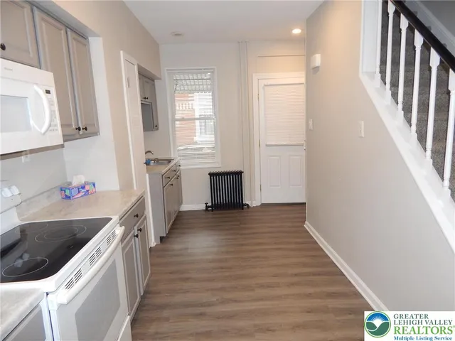 a kitchen with a sink and a stove top oven