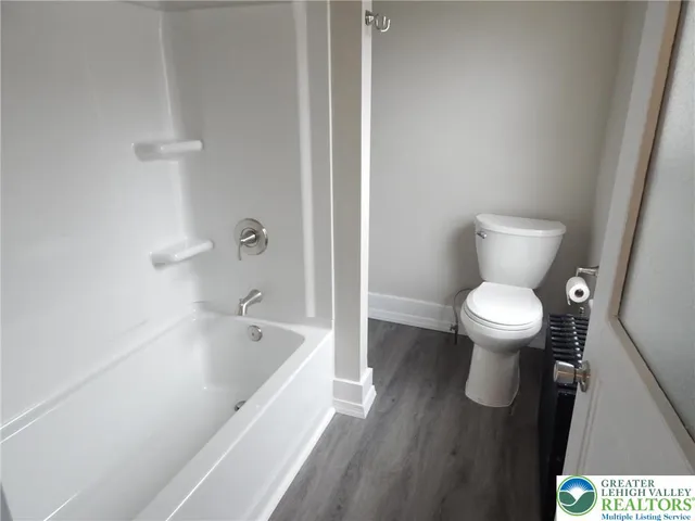 a bathroom with a toilet and a bathtub