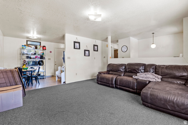 2327 880 North Provo, UT 84601 - Photo 3 of 15 Carpeted living area with overhead flush mount lighting and a suspended pendant light