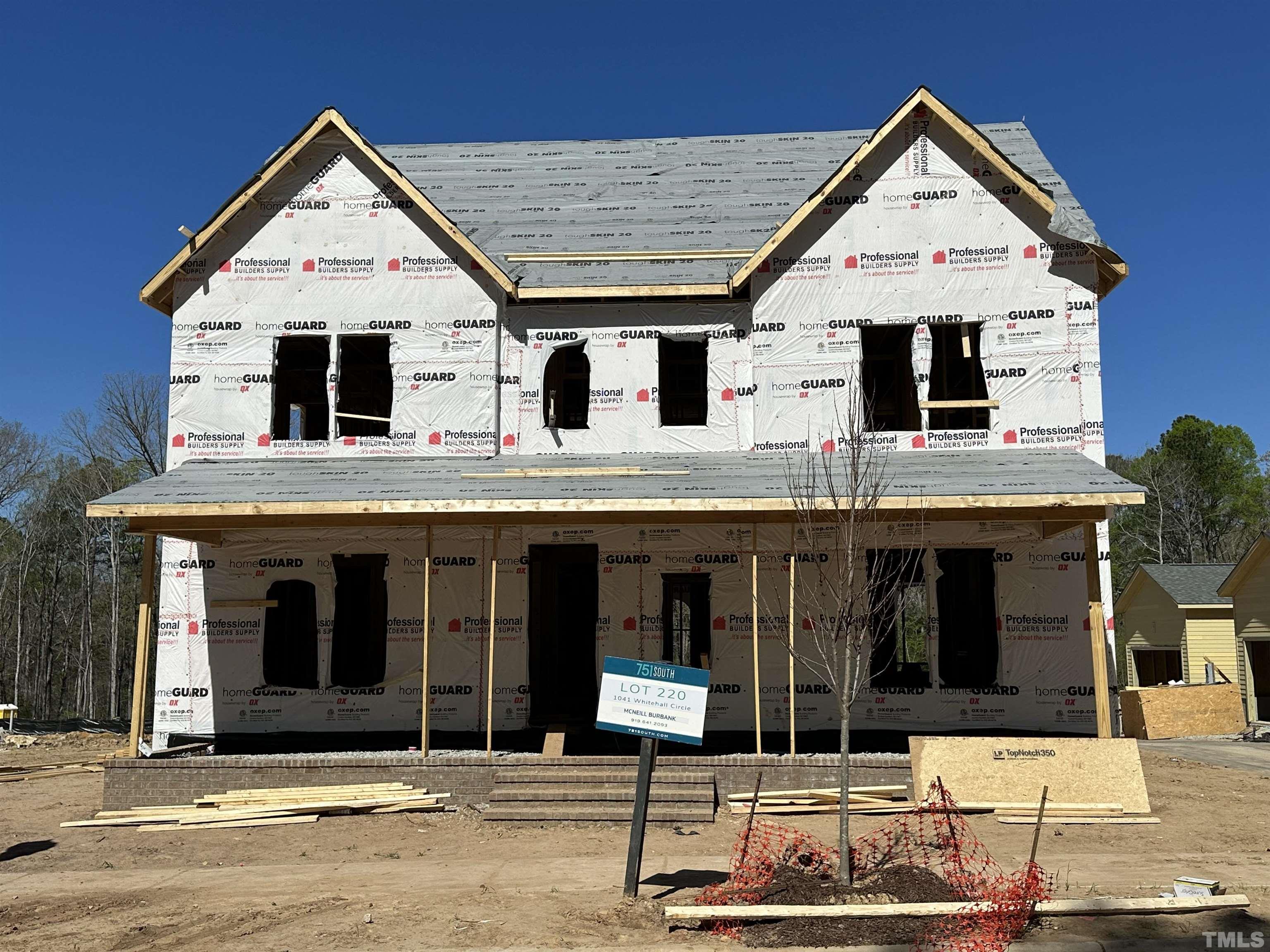 a view of a white house with large windows