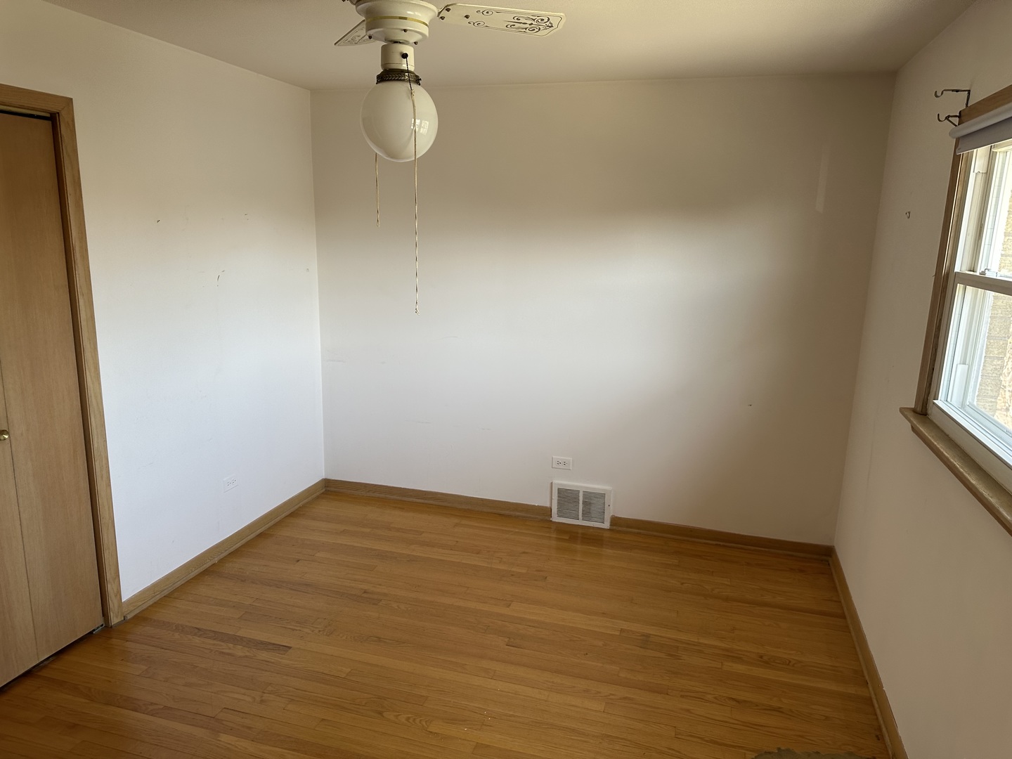 8517 South Kilbourn Avenue Chicago, IL 60652 - Photo 16 of 21 a view of an empty room with wooden floor and a window