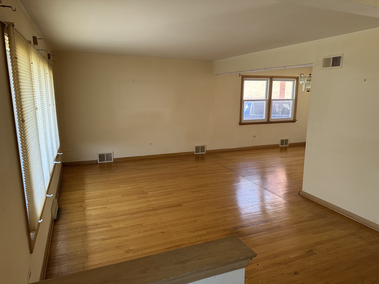 8517 South Kilbourn Avenue Chicago, IL 60652 - Photo 4 of 21 a view of an empty room with wooden floor and a window