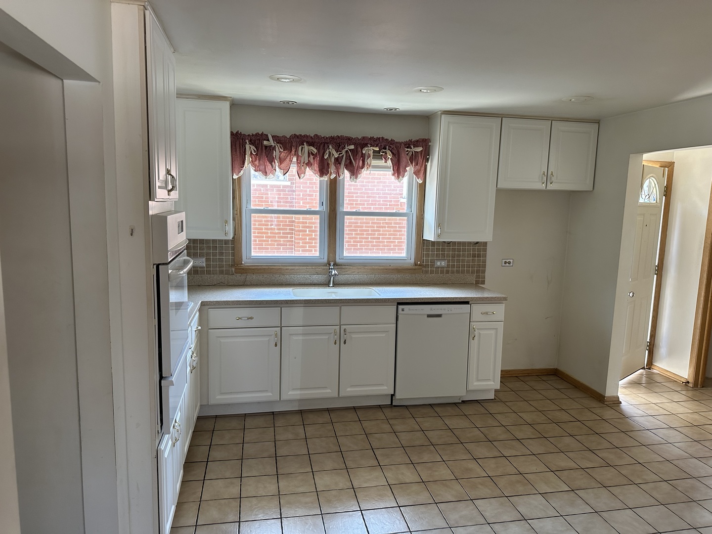 8517 South Kilbourn Avenue Chicago, IL 60652 - Photo 8 of 21 a kitchen with white cabinets and window