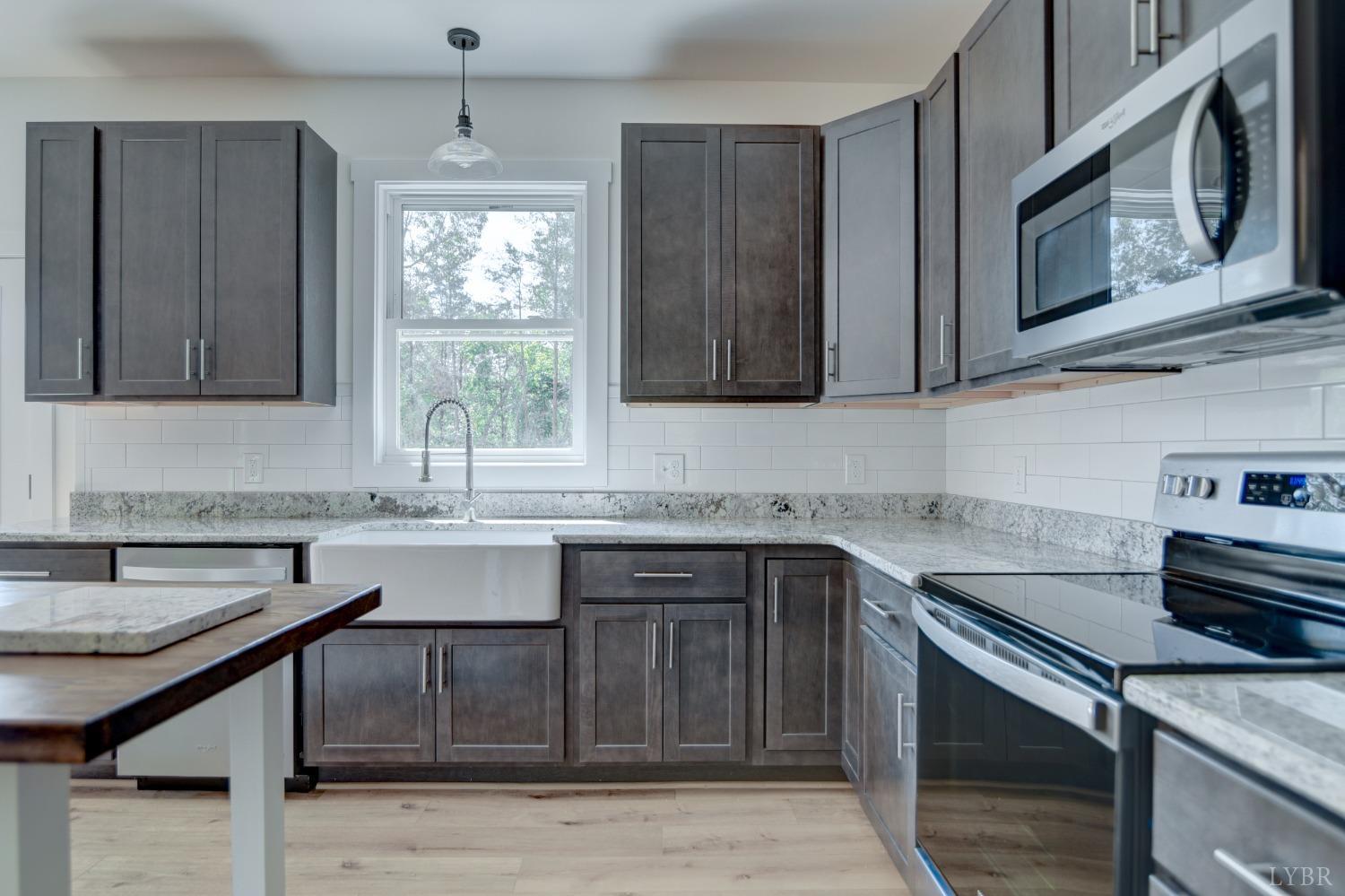 330 Bellview Road Appomattox, VA 24522 - Photo 12 of 26 a kitchen with stainless steel appliances granite countertop a sink stove and microwave