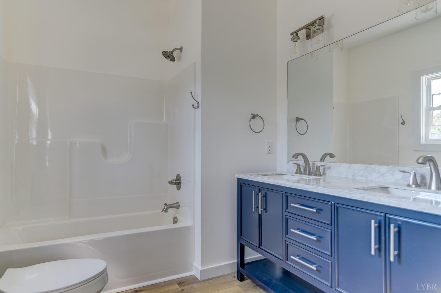330 Bellview Road Appomattox, VA 24522 - Photo 16 of 26 a bathroom with a tub sink toilet and a mirror