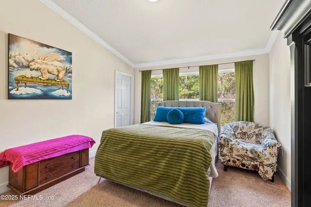 a bedroom with a bed a closet and a window