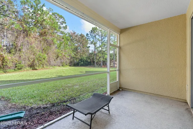 a view of a room with a big yard and potted plants