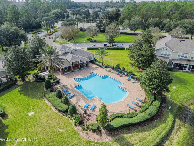 an aerial view of a house with yard swimming pool and outdoor seating