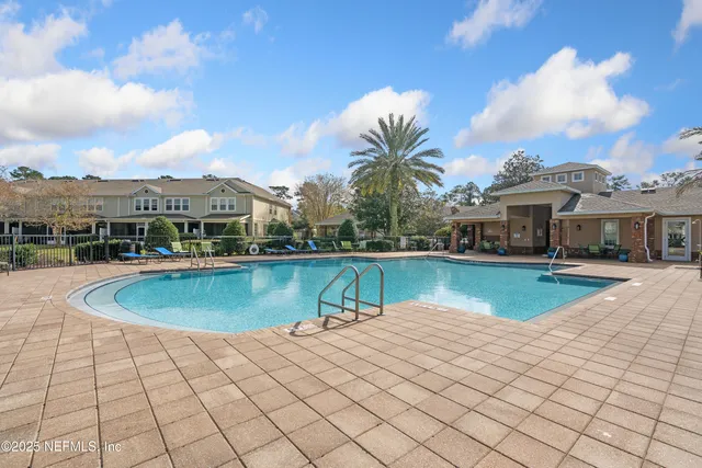 a view of a house with pool and a yard