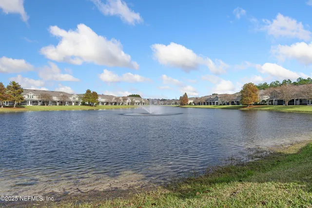 a view of a lake with houses in the background
