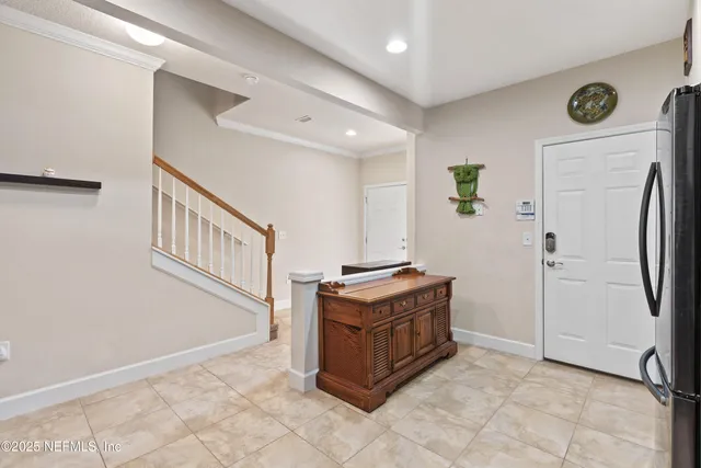 a view of kitchen with stainless steel appliances cabinets and window