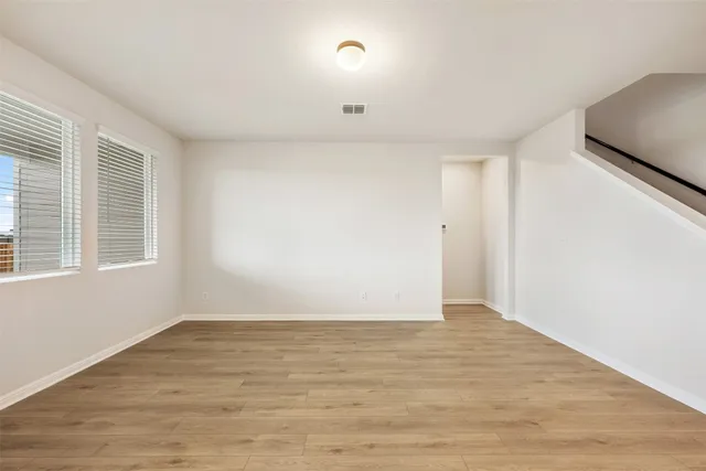 a large white kitchen with sink and white cabinets