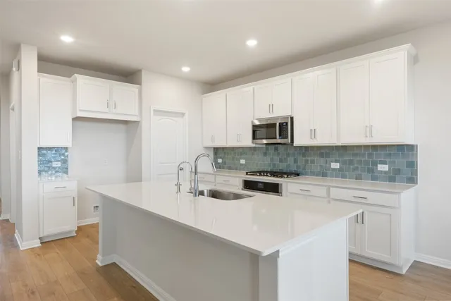 a kitchen with stainless steel appliances granite countertop a sink and cabinets