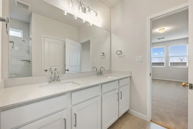 a bathroom with a glass shower door