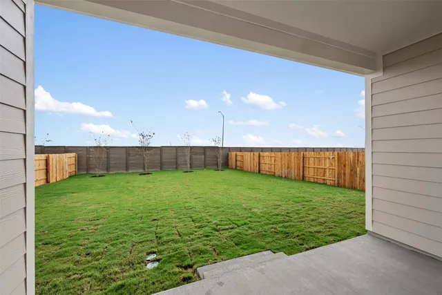 a view of a house with a yard and a garden