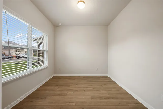 a large kitchen with stainless steel appliances a large window a sink and a oven