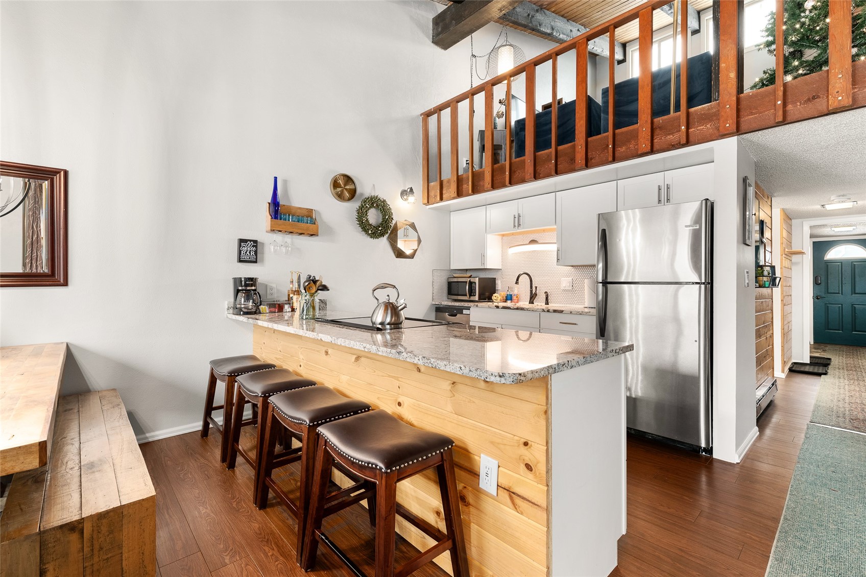 1335 Walton Creek Road, Unit 35 Steamboat Springs, CO 80487 - Photo 13 of 48 a kitchen with stainless steel appliances granite countertop a refrigerator a stove and white cabinets with wooden floor