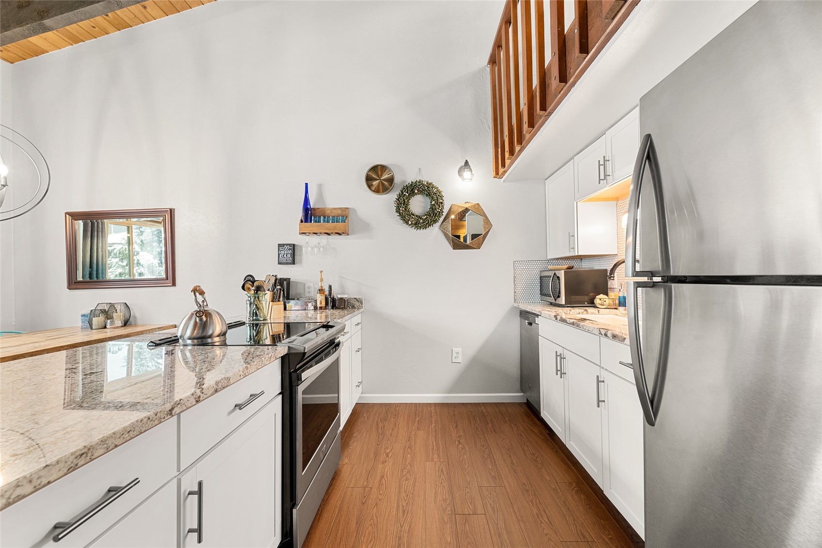1335 Walton Creek Road, Unit 35 Steamboat Springs, CO 80487 - Photo 14 of 48 a kitchen with granite countertop a sink stove and refrigerator