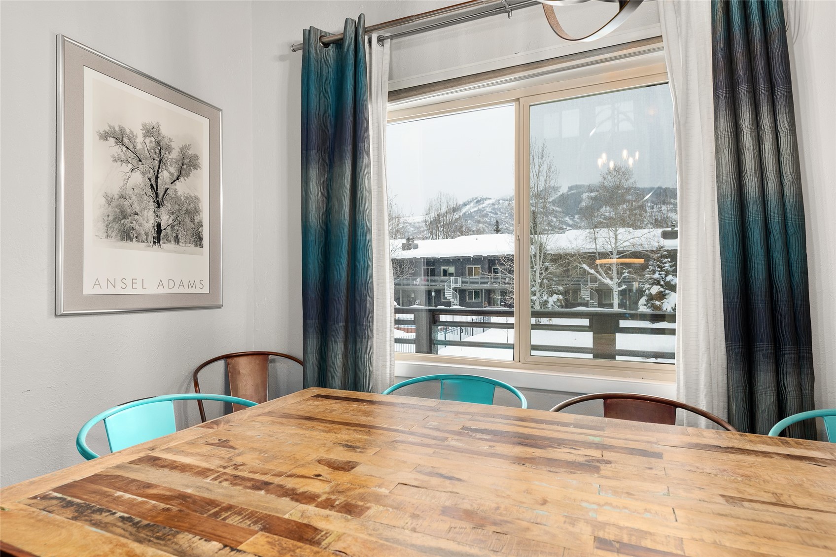 1335 Walton Creek Road, Unit 35 Steamboat Springs, CO 80487 - Photo 18 of 48 a bedroom with a large bed and a large window with the outer view