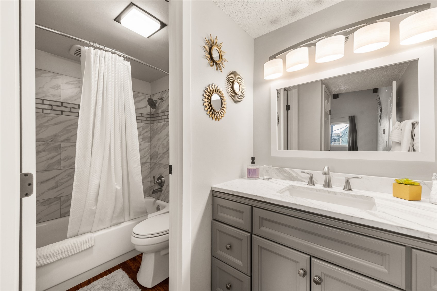 1335 Walton Creek Road, Unit 35 Steamboat Springs, CO 80487 - Photo 24 of 48 a bathroom with a granite countertop sink a toilet a mirror a vanity a shower and vanity