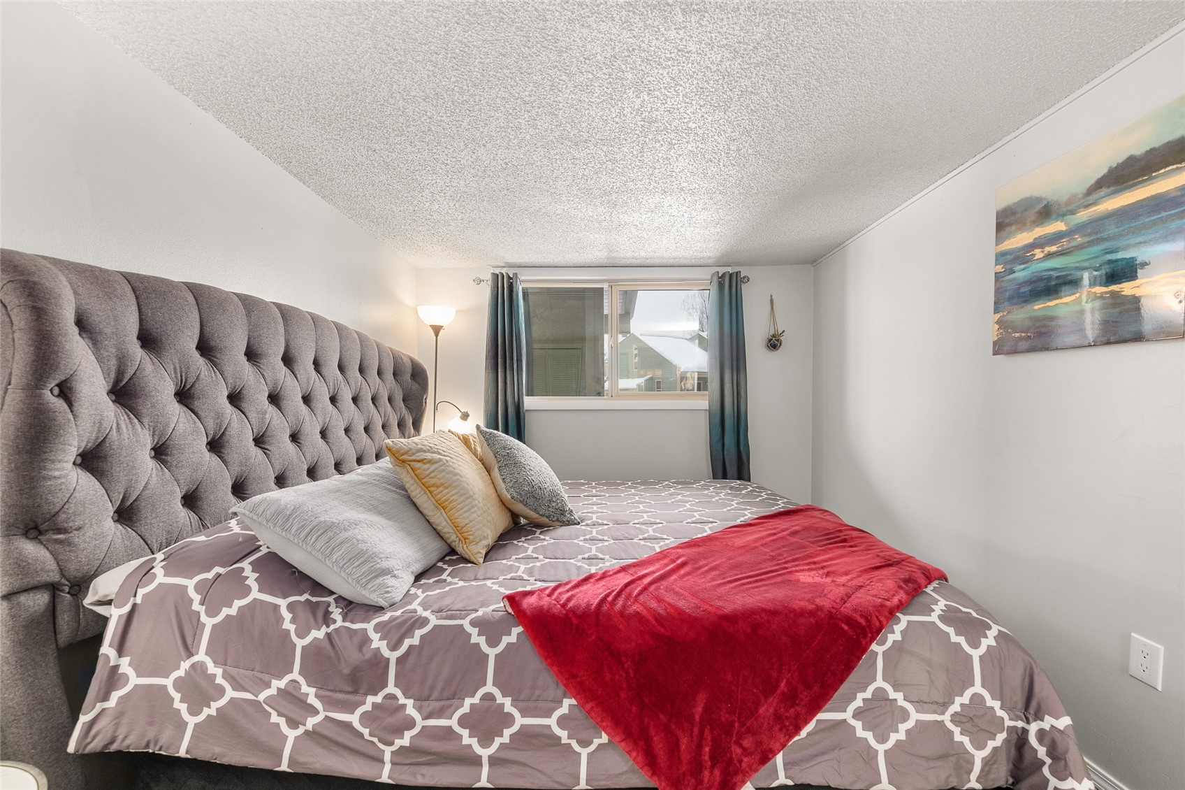 1335 Walton Creek Road, Unit 35 Steamboat Springs, CO 80487 - Photo 27 of 48 a bedroom with a large bed and a window