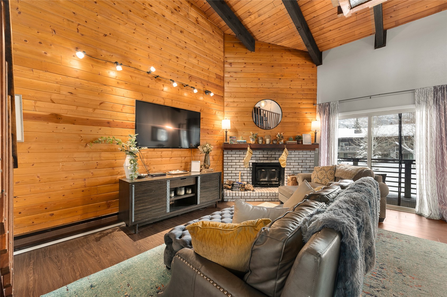 1335 Walton Creek Road, Unit 35 Steamboat Springs, CO 80487 - Photo 3 of 48 a living room with fireplace furniture and a flat screen tv