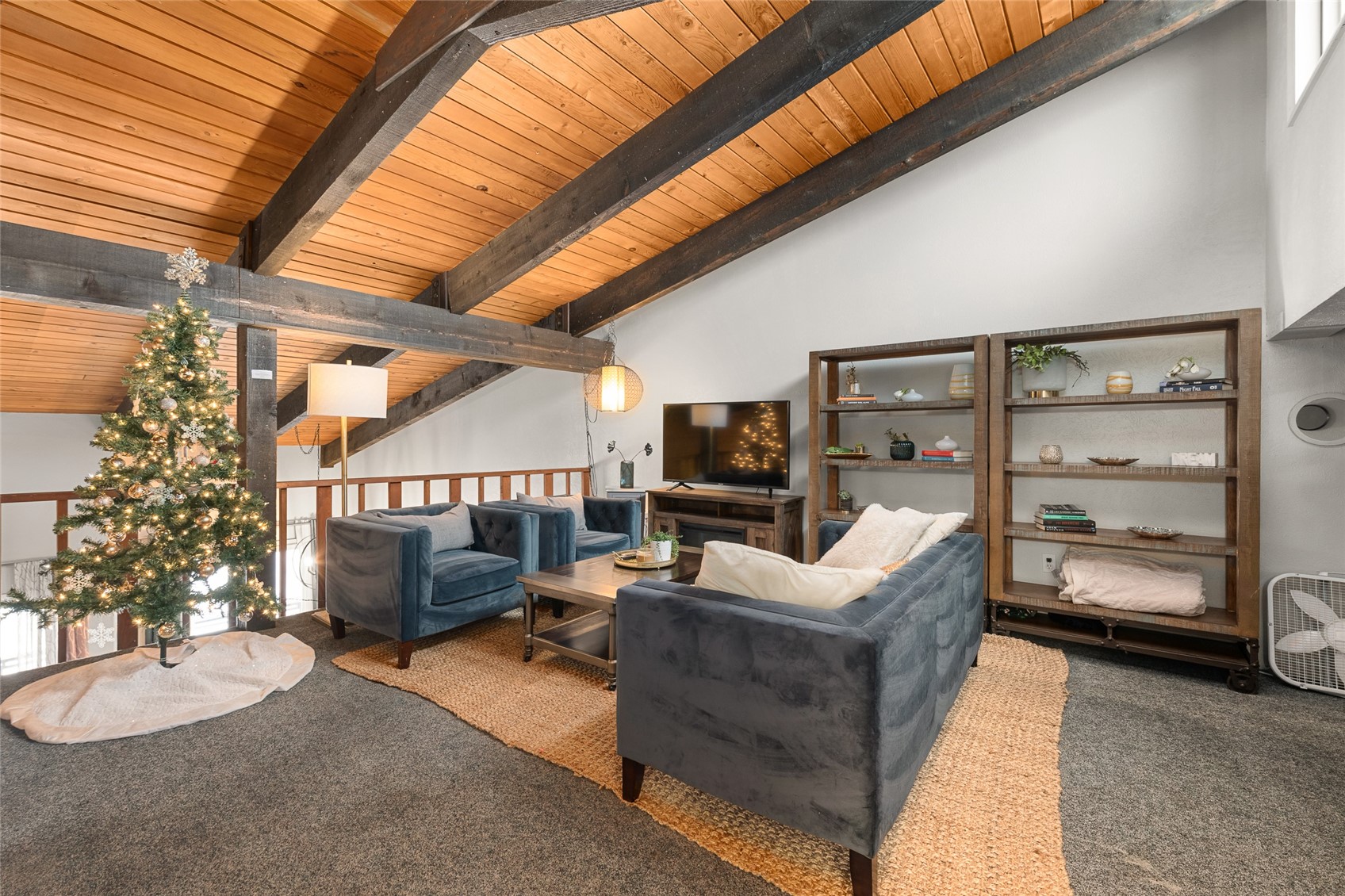 1335 Walton Creek Road, Unit 35 Steamboat Springs, CO 80487 - Photo 33 of 48 a living room with furniture a flat screen tv and a large window